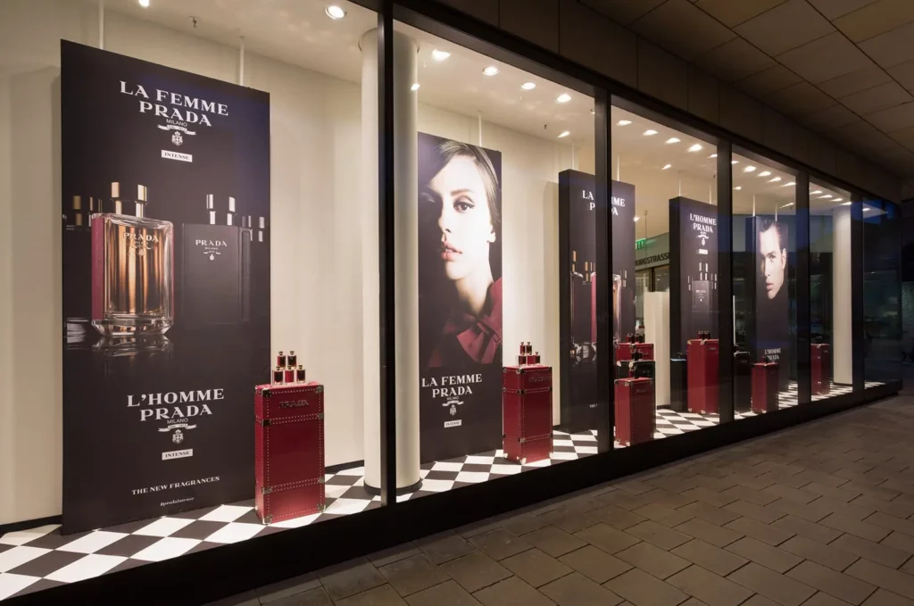 Prada Schaufenster mit Parfümdisplays und Modeplakaten