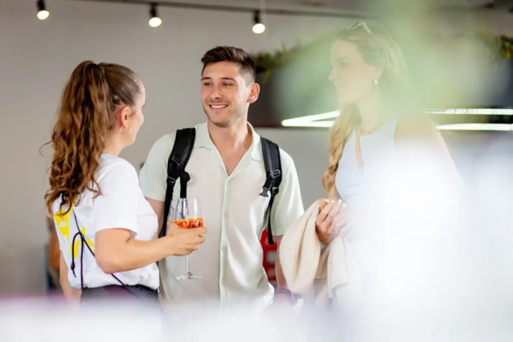 Drei Personen unterhalten sich bei einem Networking-Event